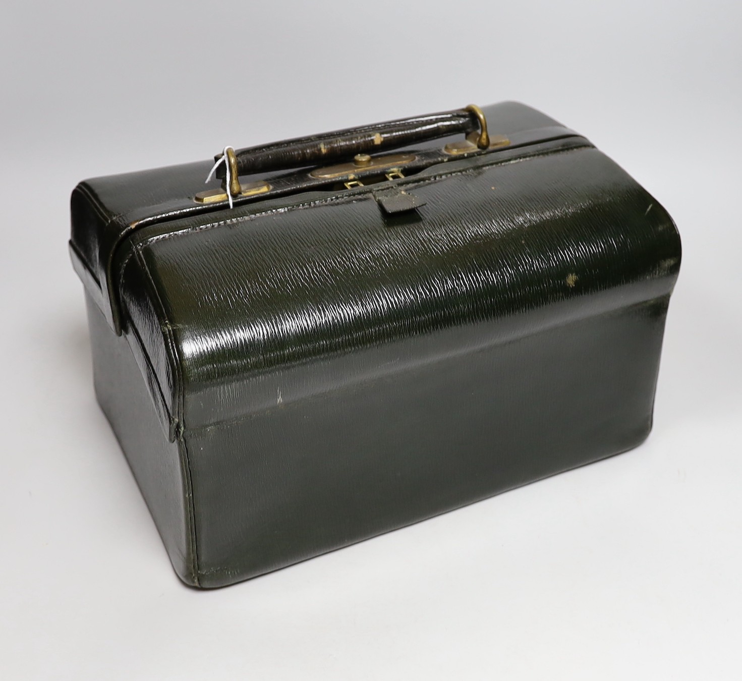 A late Victorian leather Gladstone toilet case, containing eight silver gilt mounted glass toilet jars, all engraved 'Daisy', two makers, London, 1894 & 1898, bag length 33cm.